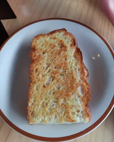 A thick slice of golden toasted focaccia