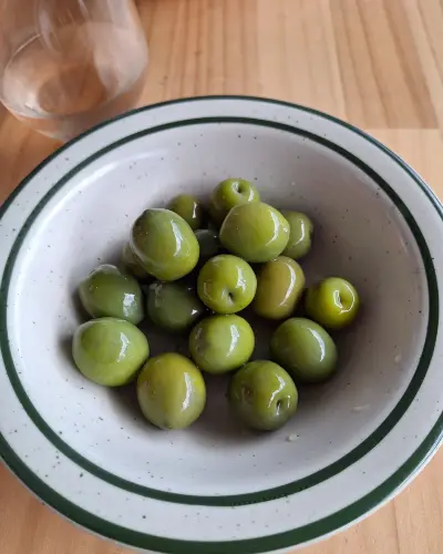 A bowl of bright green Sicilian olives