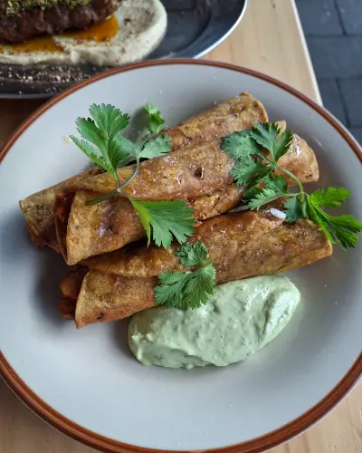 Three potato and chipotle taquitos with coriander and green mayo